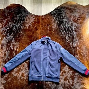 This is a Tommy Hilfiger jacket. It is a XS. The color of it is navy blue.